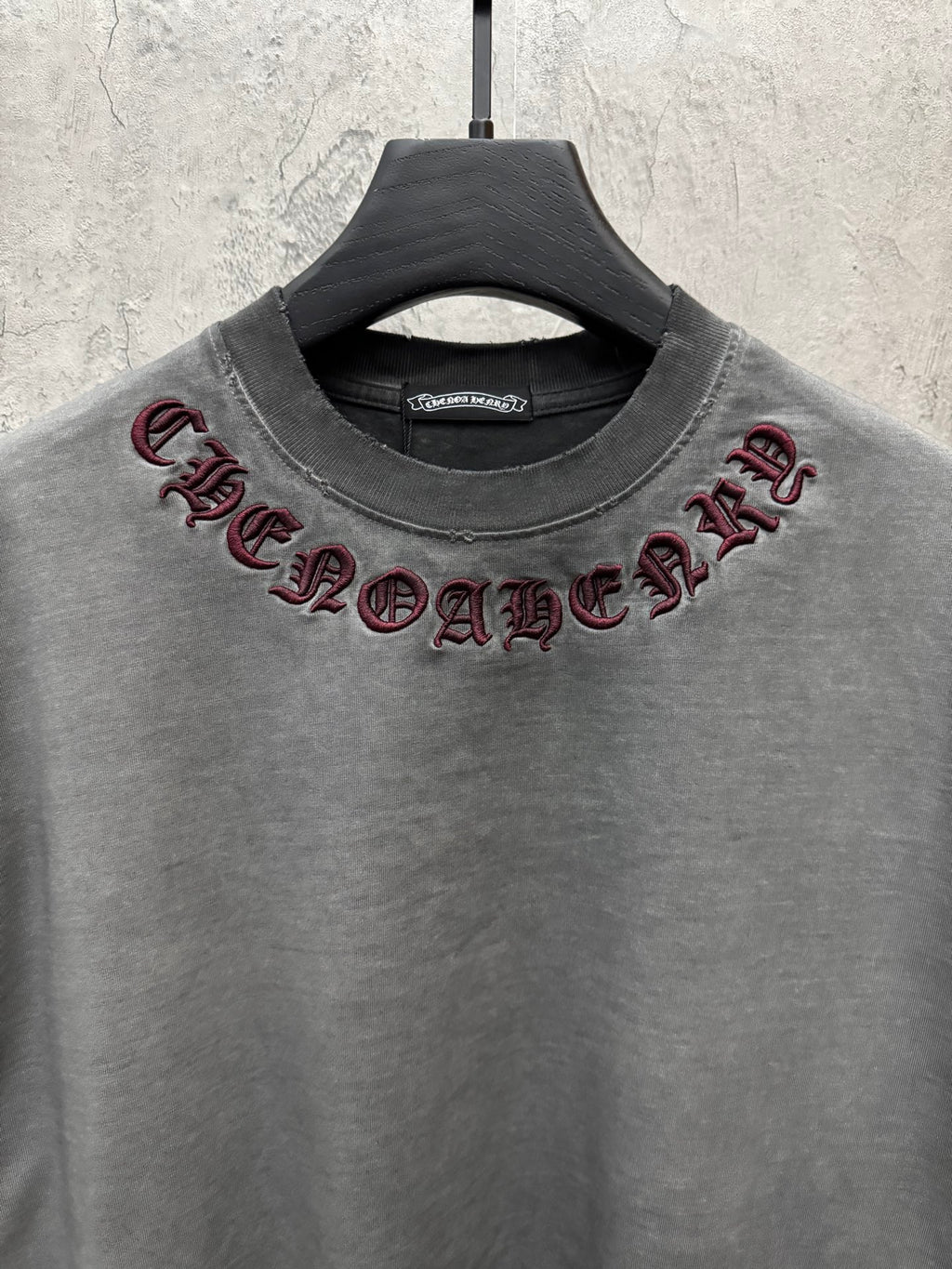 Grey crewneck T-shirt with maroon embroidered neck lettering