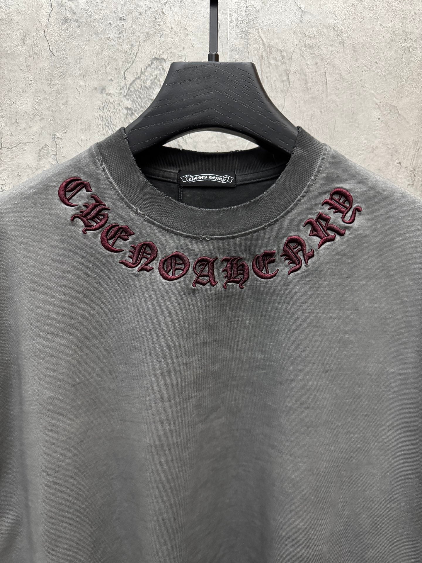 Grey crewneck T-shirt with maroon embroidered neck lettering