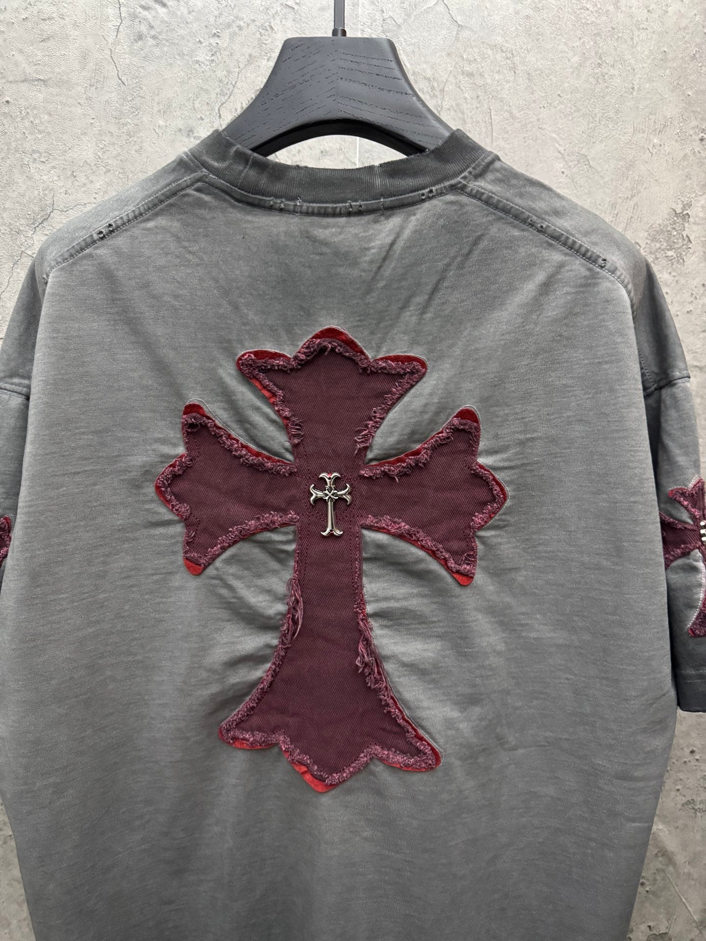 Grey short-sleeve T-shirt with maroon cross applique centered on the chest