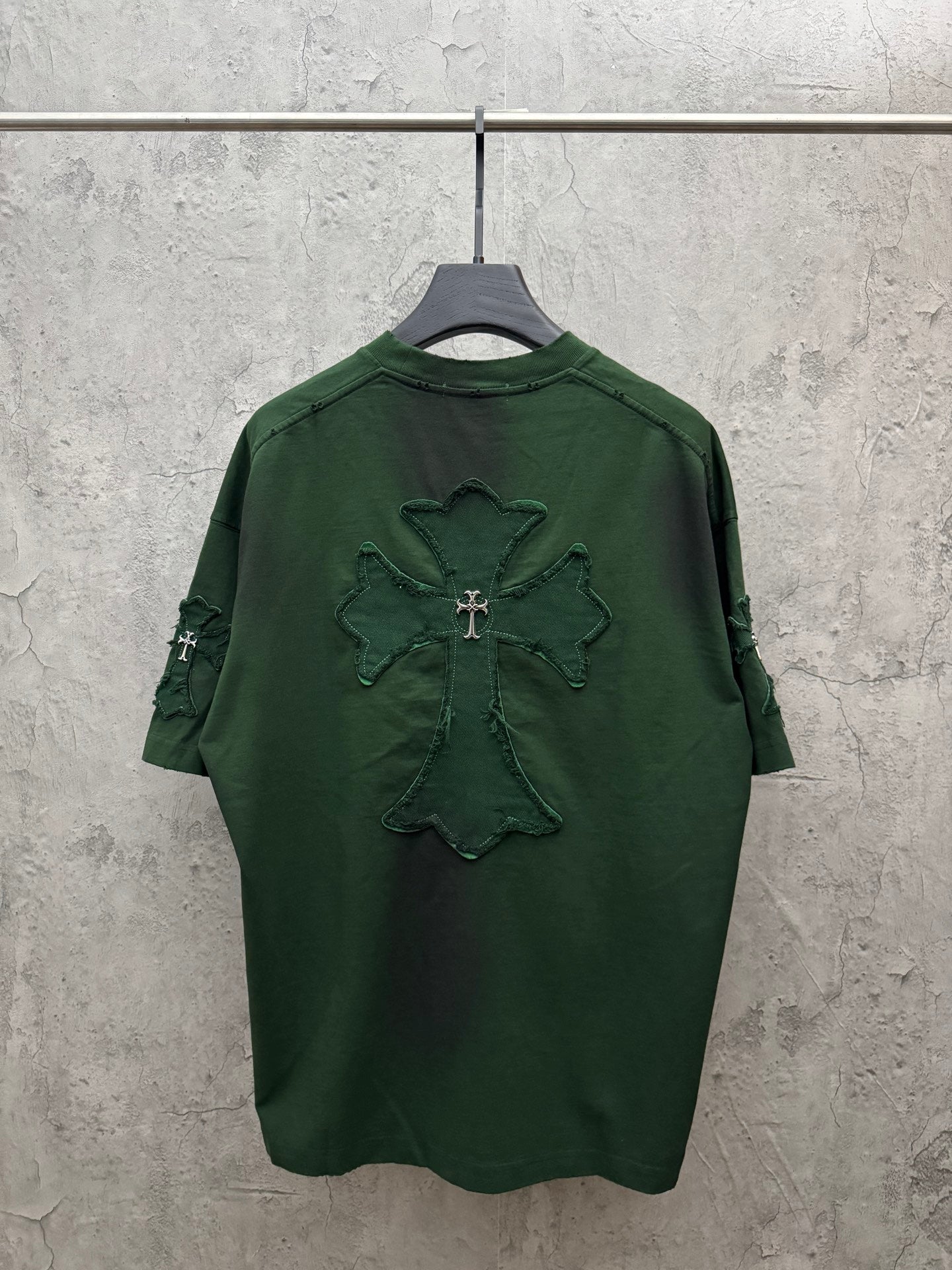 Green short-sleeve T-shirt with large embroidered angel cross graphic on back