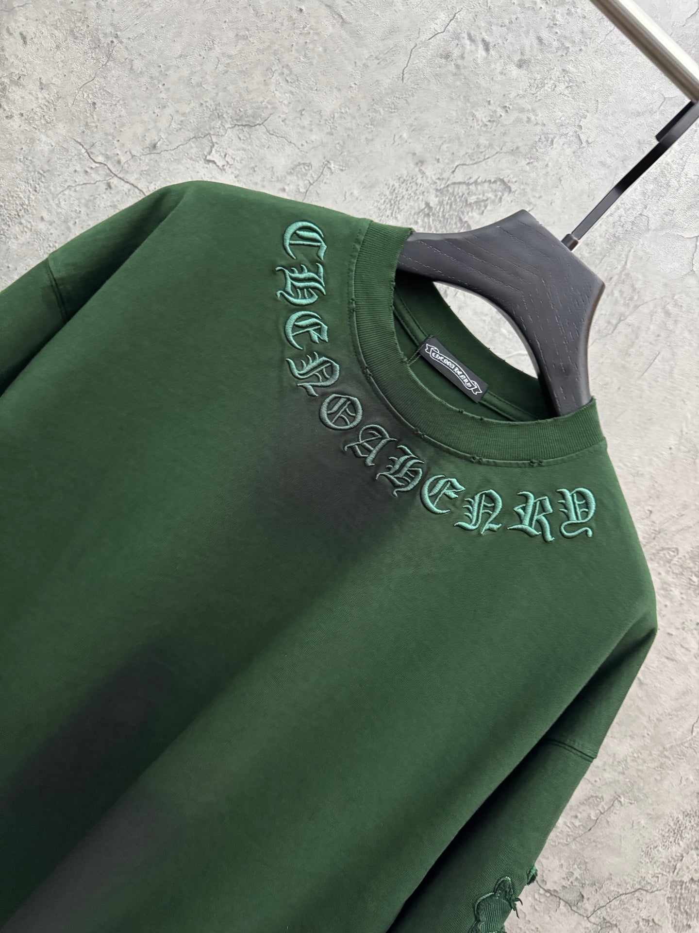 Green crew-neck T-shirt with embroidered script logo at neckline