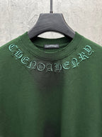 Green short-sleeve T-shirt close-up of crew neck with arched embroidered graphic
