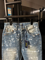 Distressed light-wash denim jeans with button fly, belt loops, front view