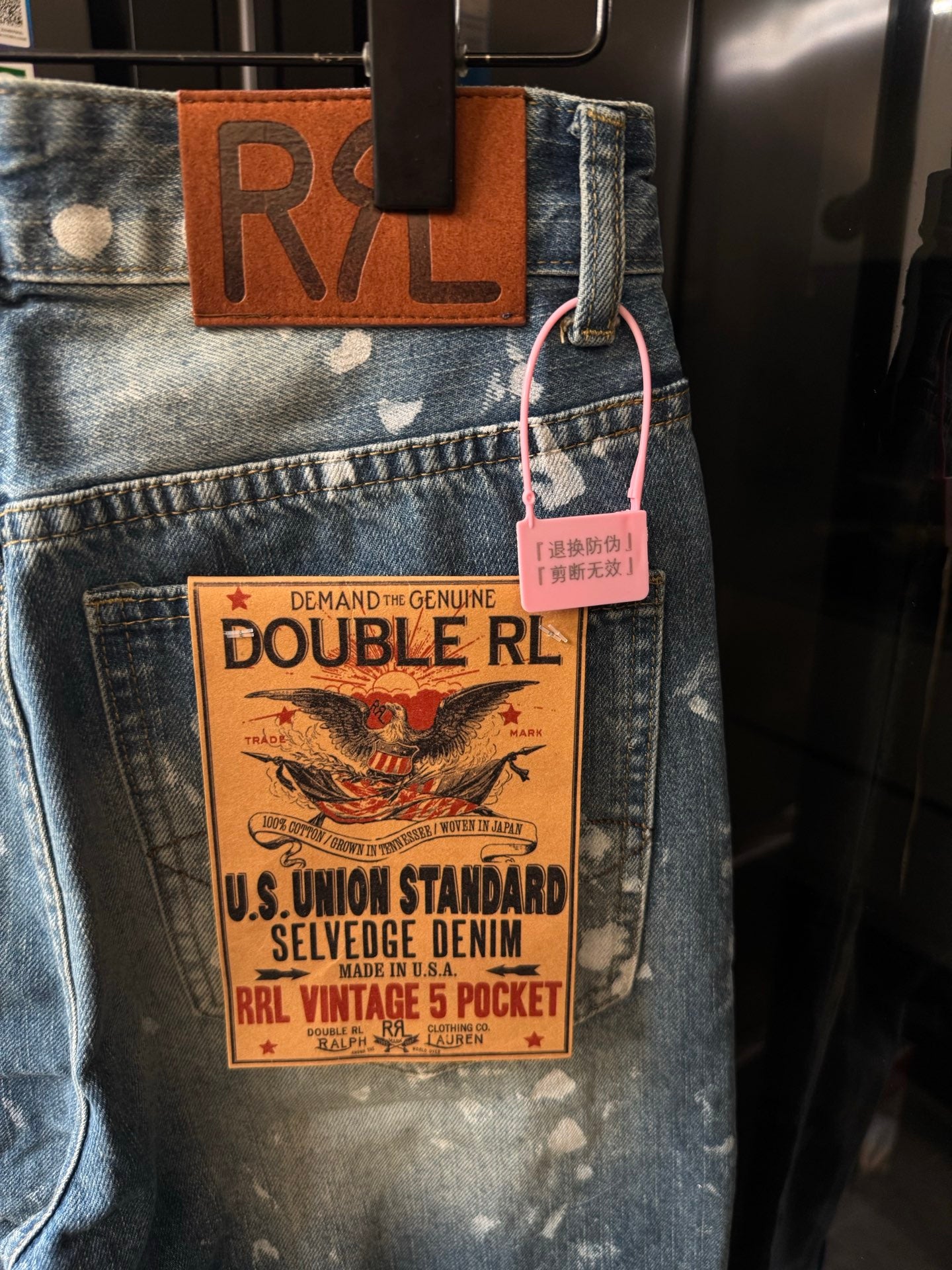 Distressed denim jeans with DOUBLE RL tag and white speckle splatter