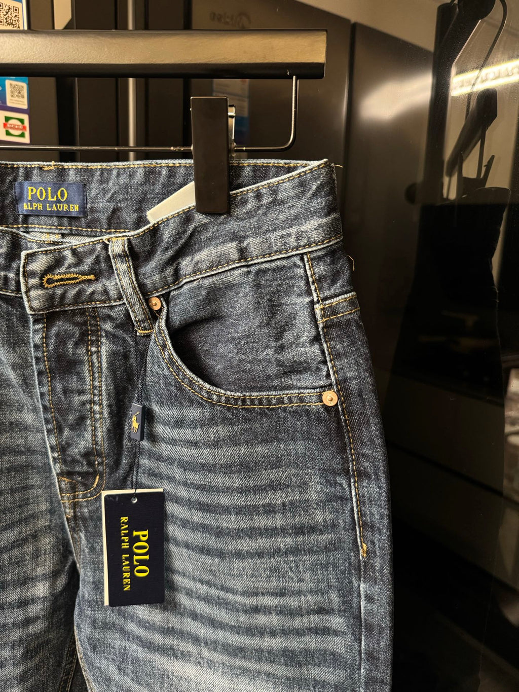 Light blue denim jeans with curved front pocket openings and POLO Ralph Lauren hang tag