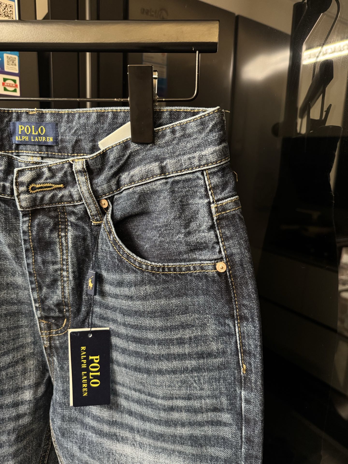 Light blue denim jeans with curved front pocket openings and POLO Ralph Lauren hang tag