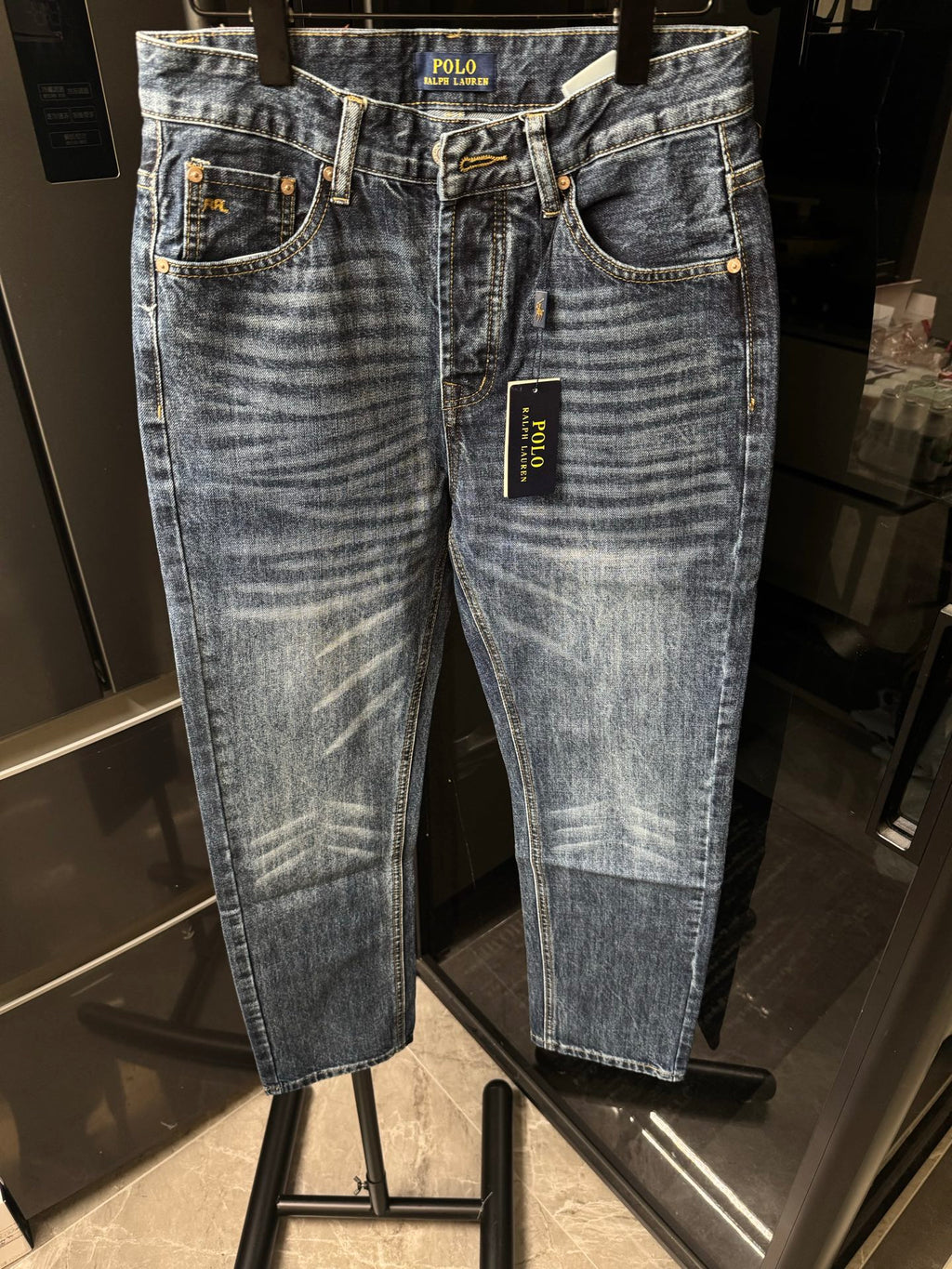 Light blue denim jeans with front pockets, belt loops, and POLO Ralph Lauren label tag