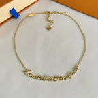 Gold-tone chain bracelet with engraved nameplate links across the front