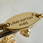 Gold-tone oval pendant engraved Louis Vuitton Paris on necklace chain