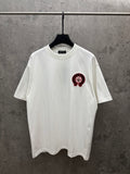 White crew-neck T-shirt with small red-and-black chest logo graphic.