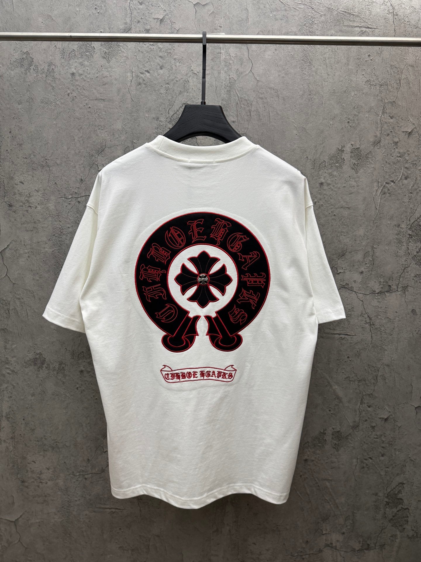 White crew-neck T-shirt with large red-and-black circular back graphic