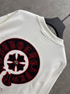 White T-shirt with large close-up red-and-black circular graphic print.