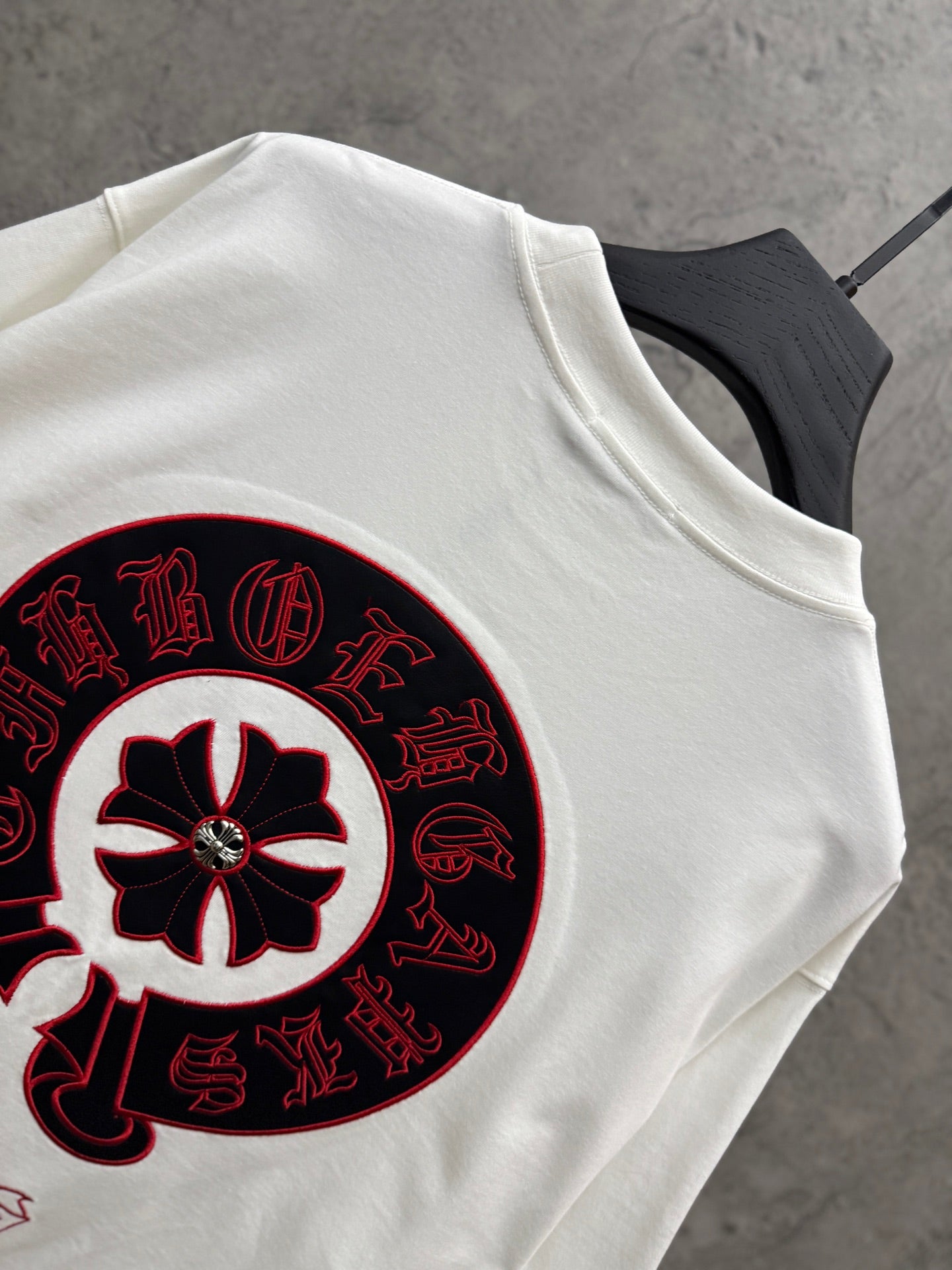 White T-shirt with large close-up red-and-black circular graphic print.