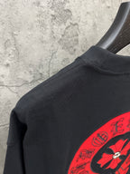 Black short-sleeve T-shirt side view with red logo on sleeve/hem area