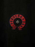 Black short-sleeve T-shirt with close-up black-and-red circular chest emblem