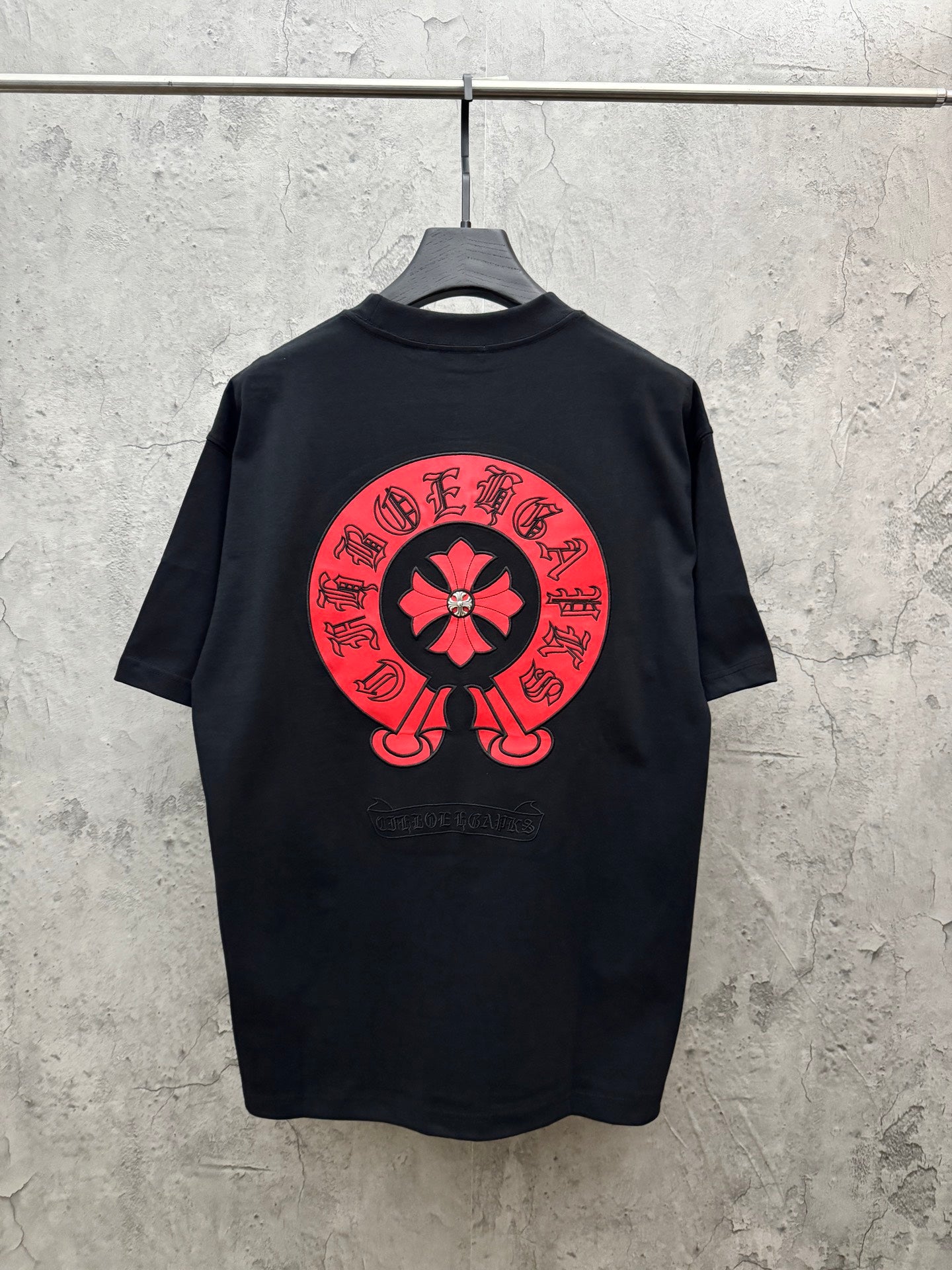 Black short-sleeve T-shirt with large red flower back graphic and ring text