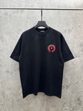 Black short-sleeve T-shirt with small red-and-black chest emblem