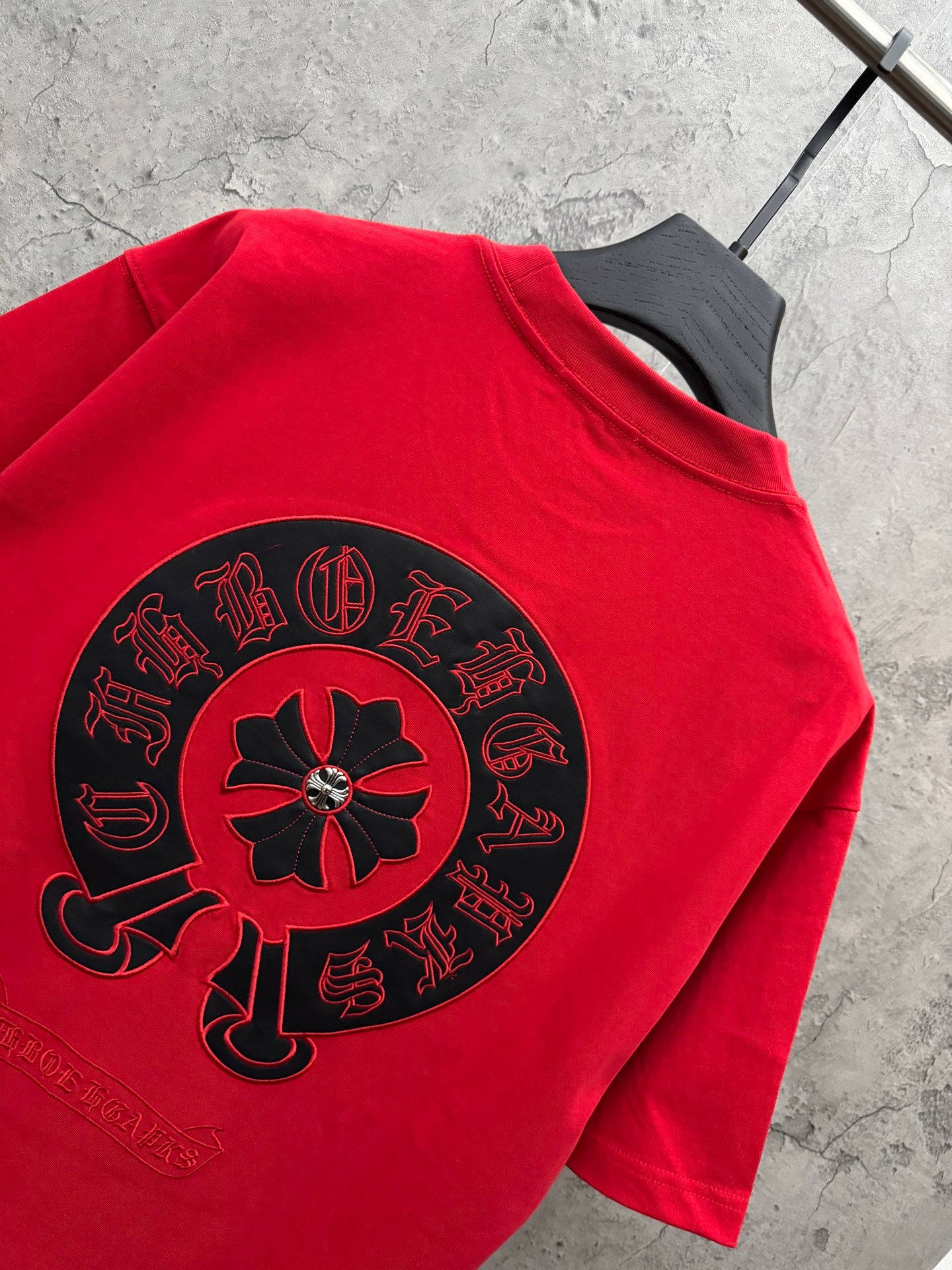Red T-shirt with large black back graphic and red flower center