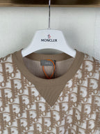 Tan short-sleeve top with crew-to-V neckline ribbed trim and logo pattern