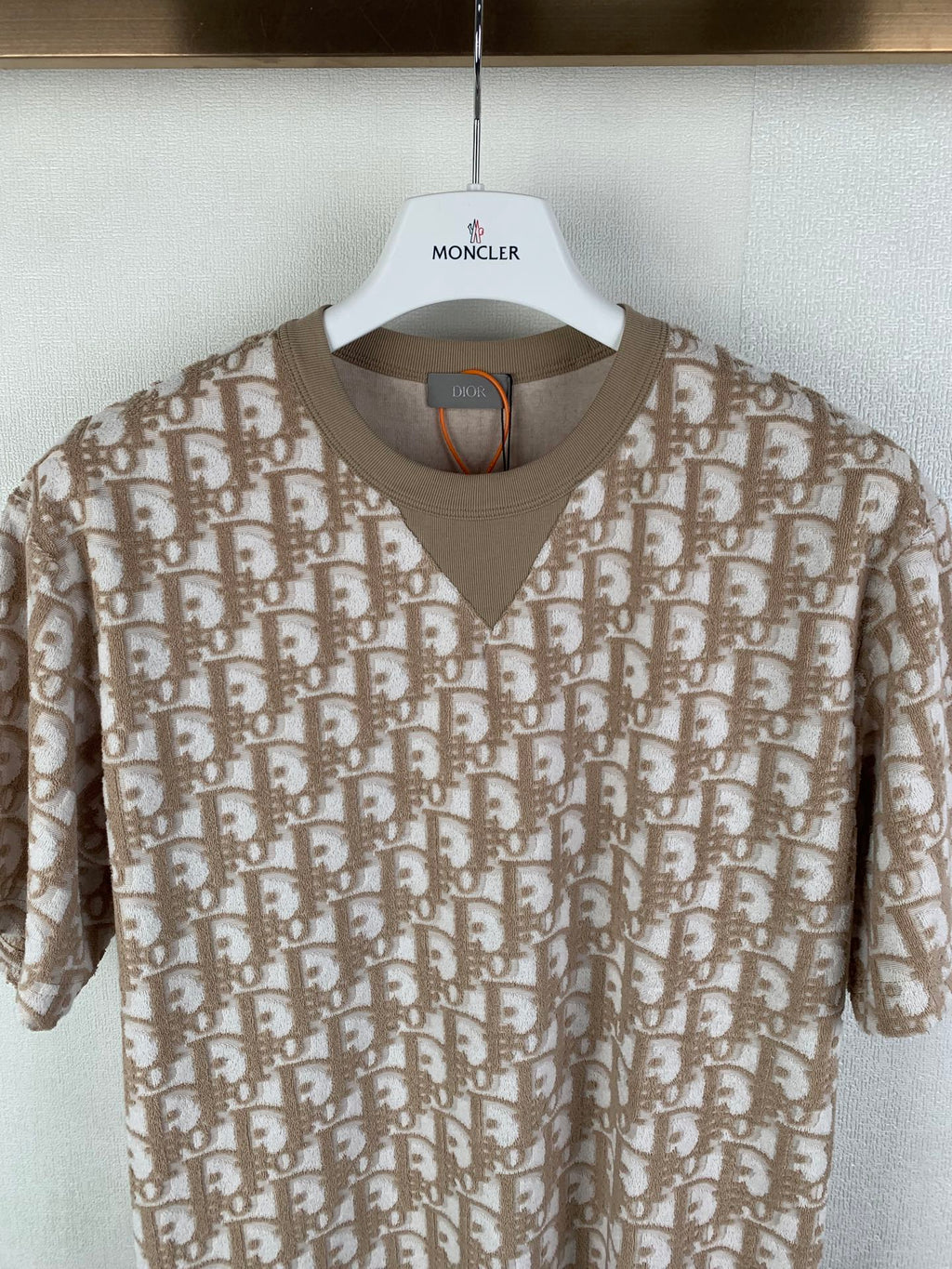Tan Dior short-sleeve top with V-neck and allover logo print