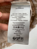 Clothing care label showing 100% cotton and made in Italy