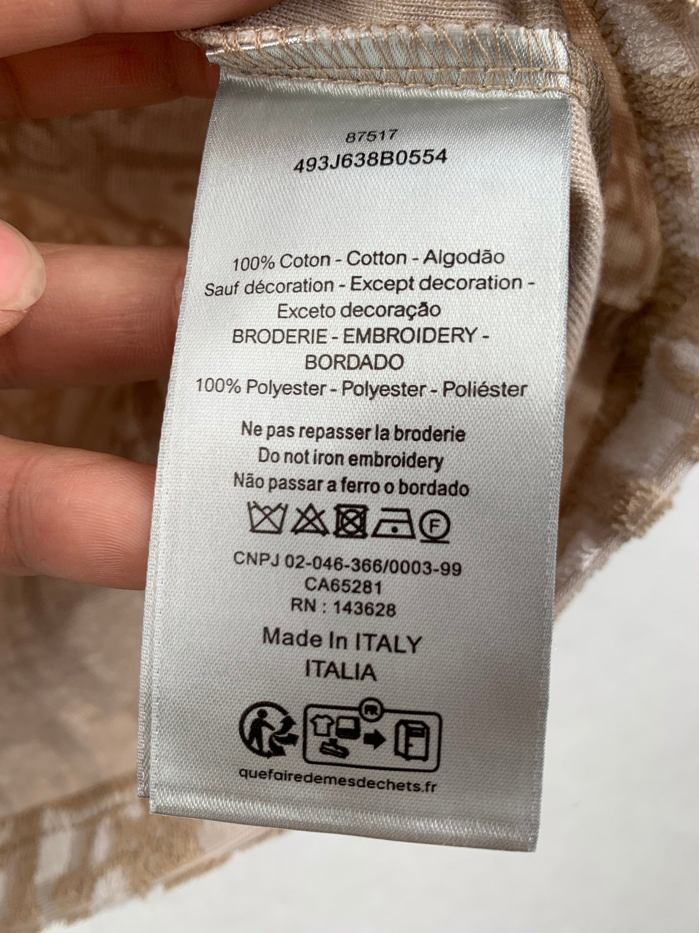 Clothing care label showing 100% cotton and made in Italy