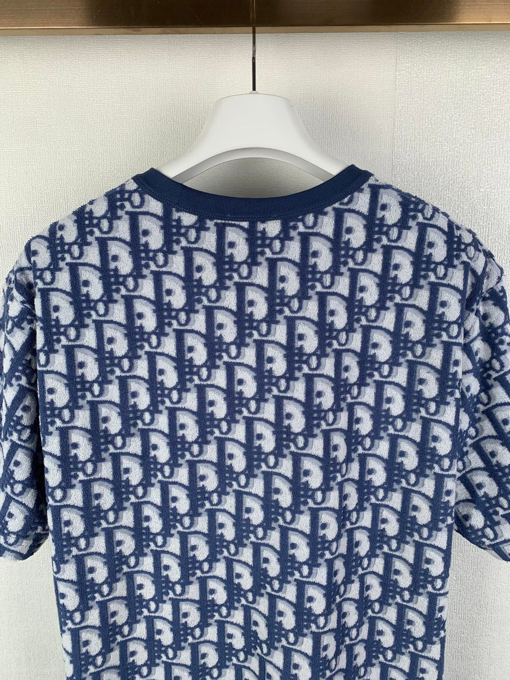 Short-sleeve T-shirt with allover navy-and-white logo pattern, rear view
