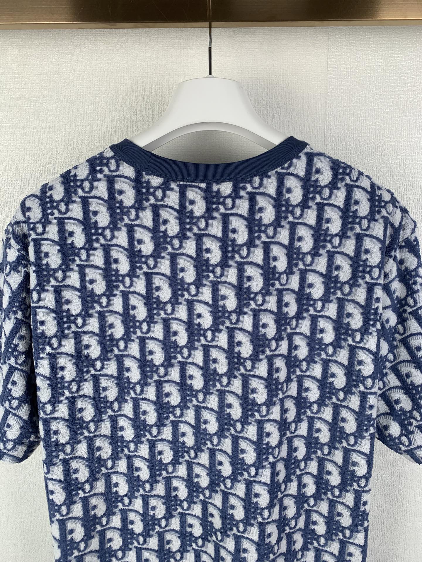 Short-sleeve T-shirt with allover navy-and-white logo pattern, rear view