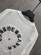 White T-shirt with close-up embroidered circular patch logo on the sleeve chest area