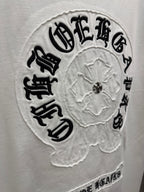 Close-up of embroidered round back logo patch on white T-shirt