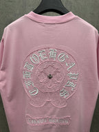 Pink short-sleeve crewneck T-shirt showing large back embroidered circular emblem
