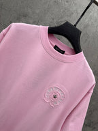 Pink short-sleeve T-shirt close-up of chest embroidered flower emblem