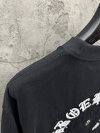 Chrome short-sleeve T-shirt back corner with embroidered text and dark fabric