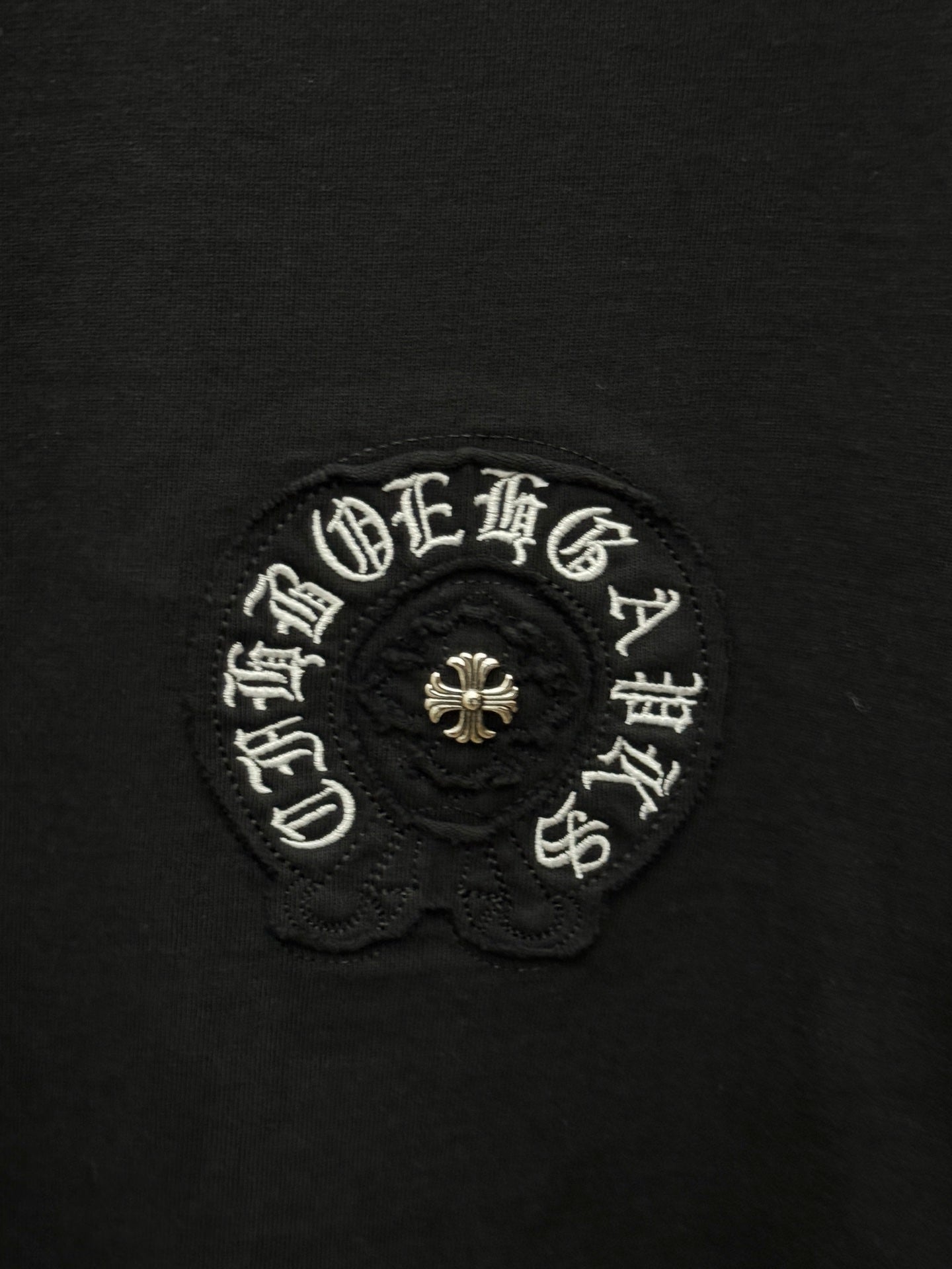 Chrome short-sleeve T-shirt close-up of circular embroidered emblem with bead detail
