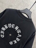 Black T-shirt close-up of large circular embroidered back graphic