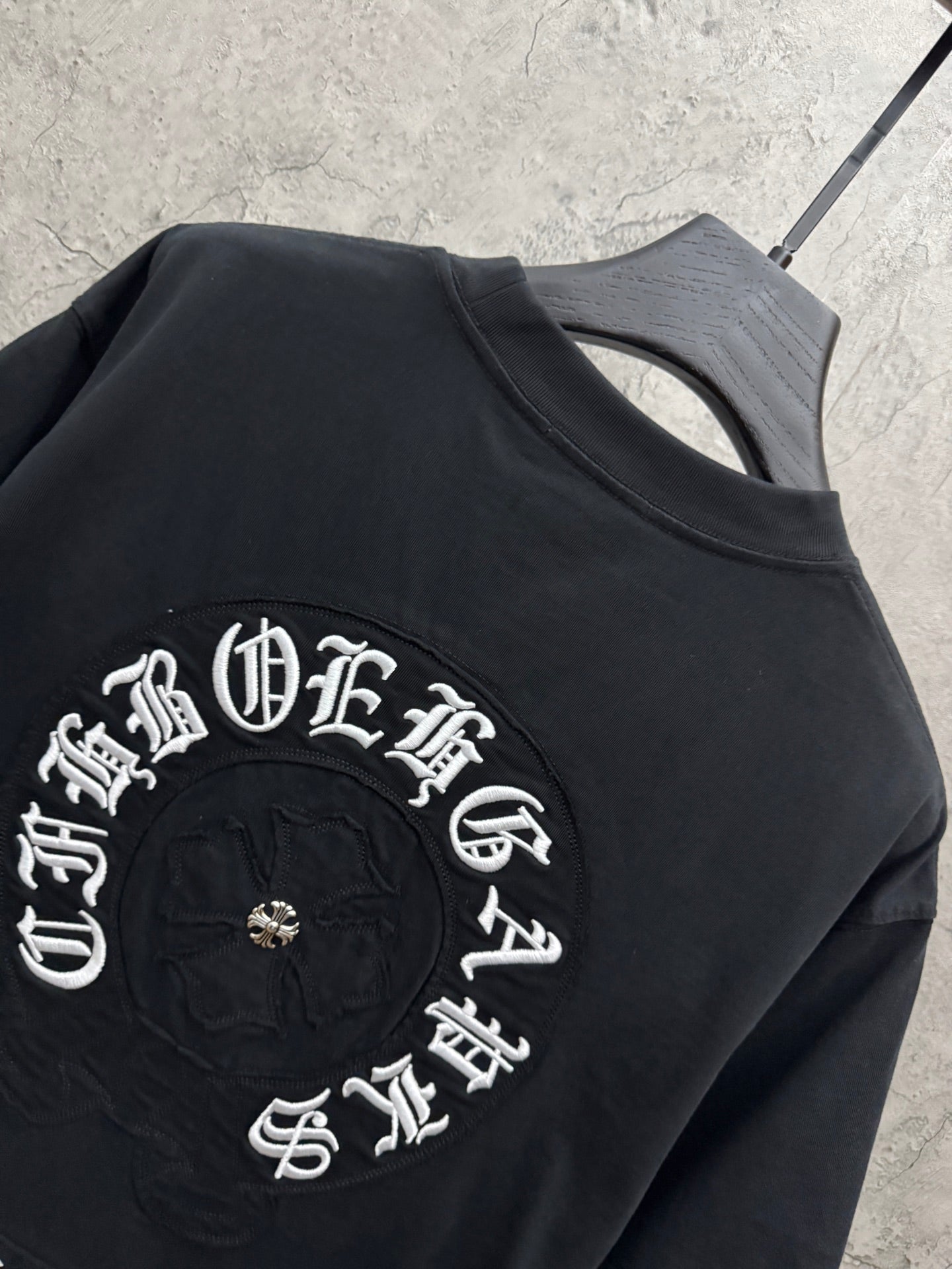 Black T-shirt close-up of large circular embroidered back graphic