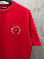 Red crewneck T-shirt with small chest embroidered crest and visible hem