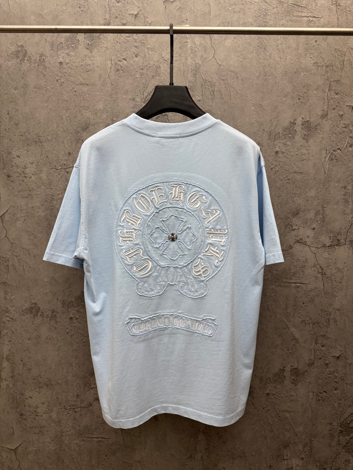 Light blue crewneck T-shirt showing large back embroidered crest
