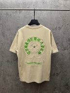 Light cream T-shirt with large green embroidered back graphic and floral patch