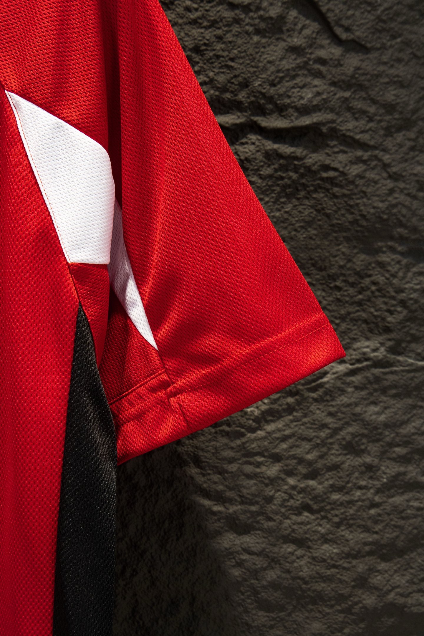 Red Balenciaga jersey sleeve with white side stripe panel and folded fabric
