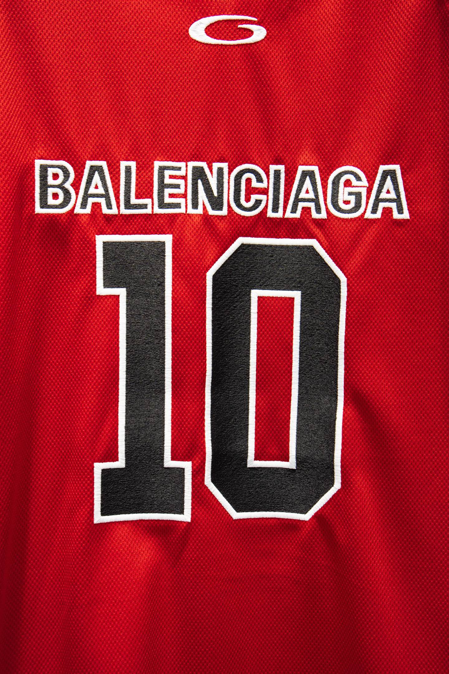Red Balenciaga jersey detail with 'BALENCIAGA' text and large '10' graphic