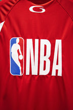 Red Balenciaga jersey detail with NBA logo and silhouetted player graphic