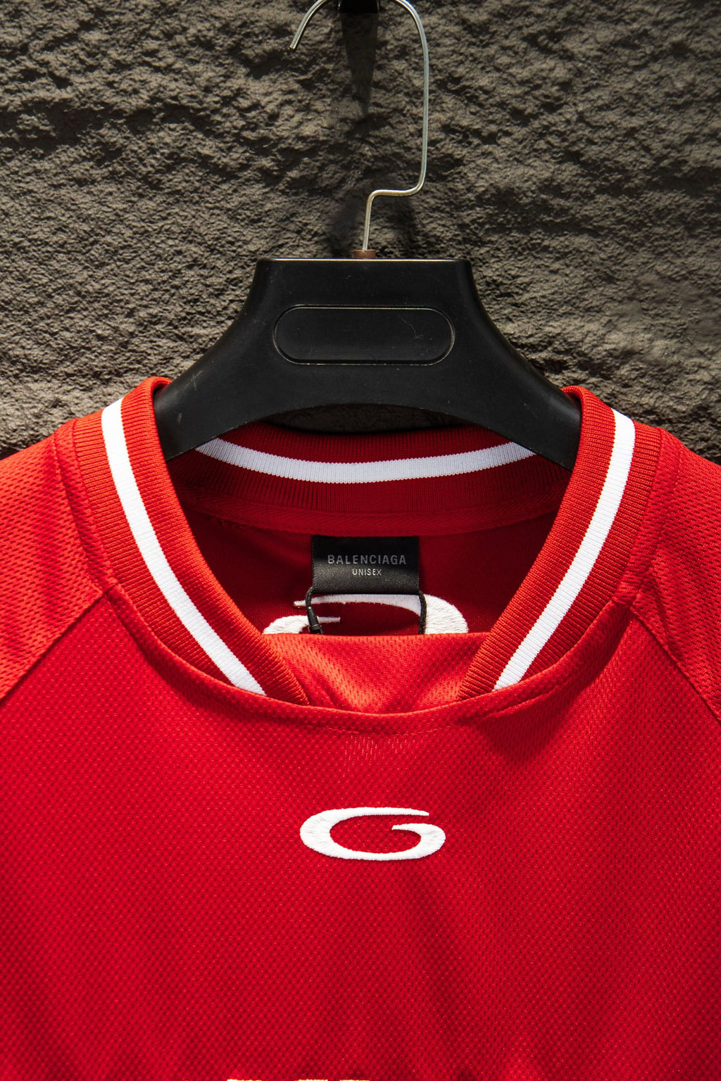 Red Balenciaga jersey neckline with ribbed white-trim collar and small crest