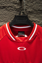 Red Balenciaga jersey neckline with ribbed white-trim collar and small crest