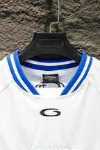 Balenciaga short-sleeve jersey neckline, blue-and-white ribbed collar with small G logo.