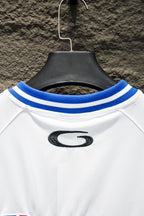 Balenciaga short-sleeve jersey collar, blue-striped ribbing with black G logo.