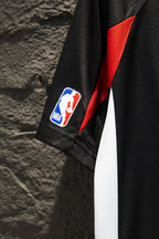 Black jersey sleeve with red angular panel and NBA patch logo