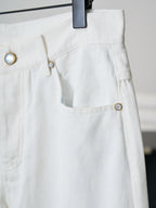 Louis Vuitton white denim pants with curved pocket opening and button detail