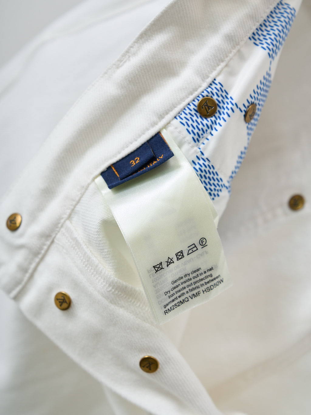 Louis Vuitton pants, light denim with gold buttons and brand label inside seam