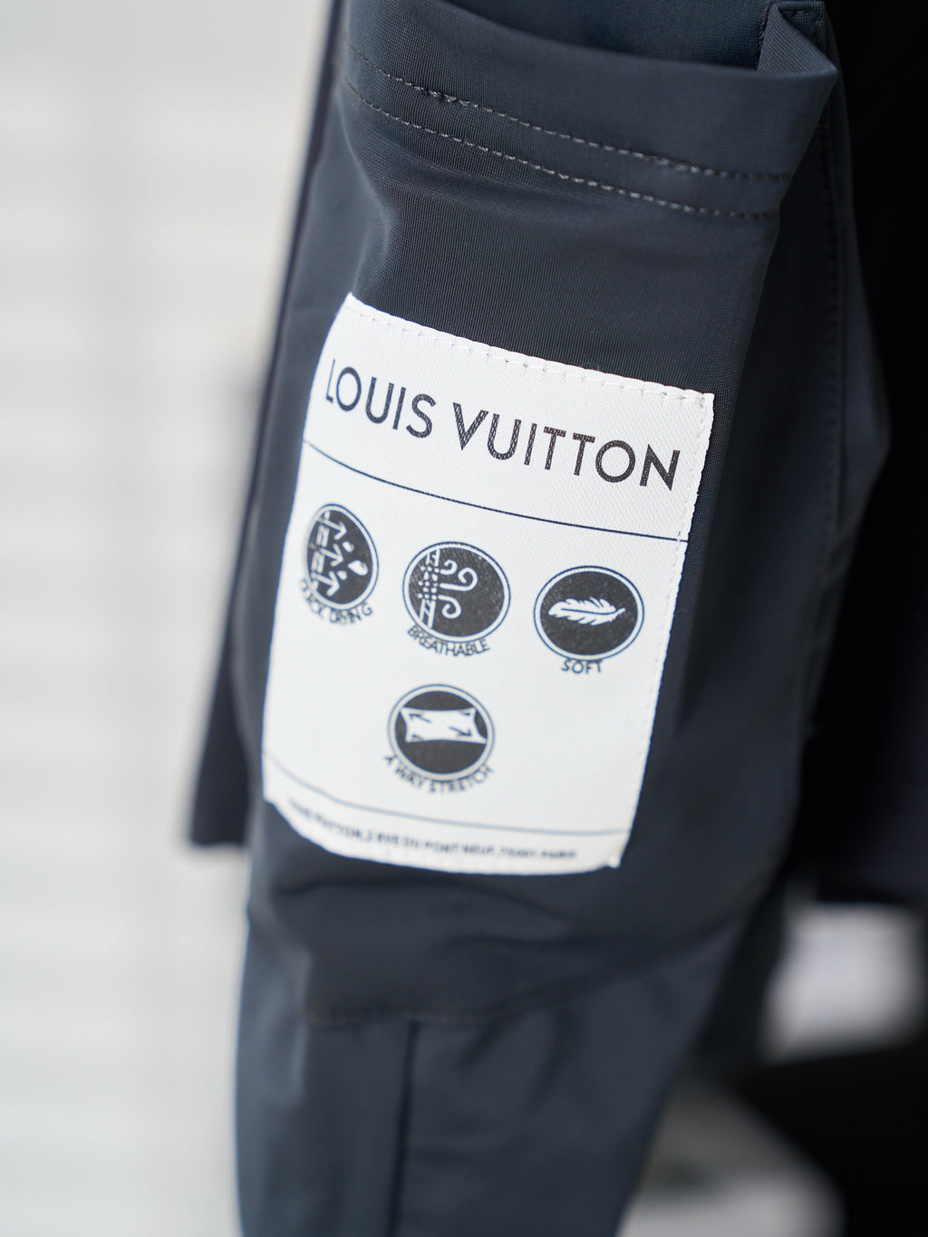 Louis Vuitton navy shorts with size label and care icons on inner pocket
